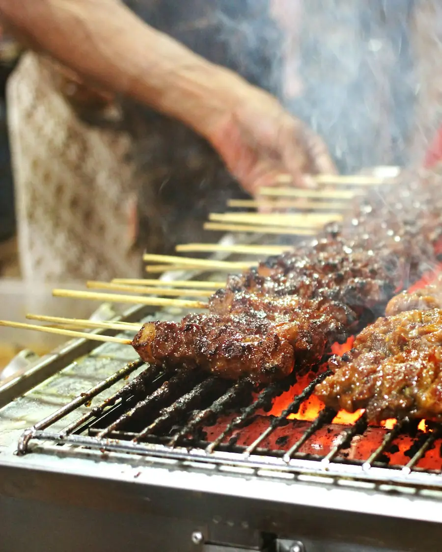 Satay skewers grilling over hot charcoal