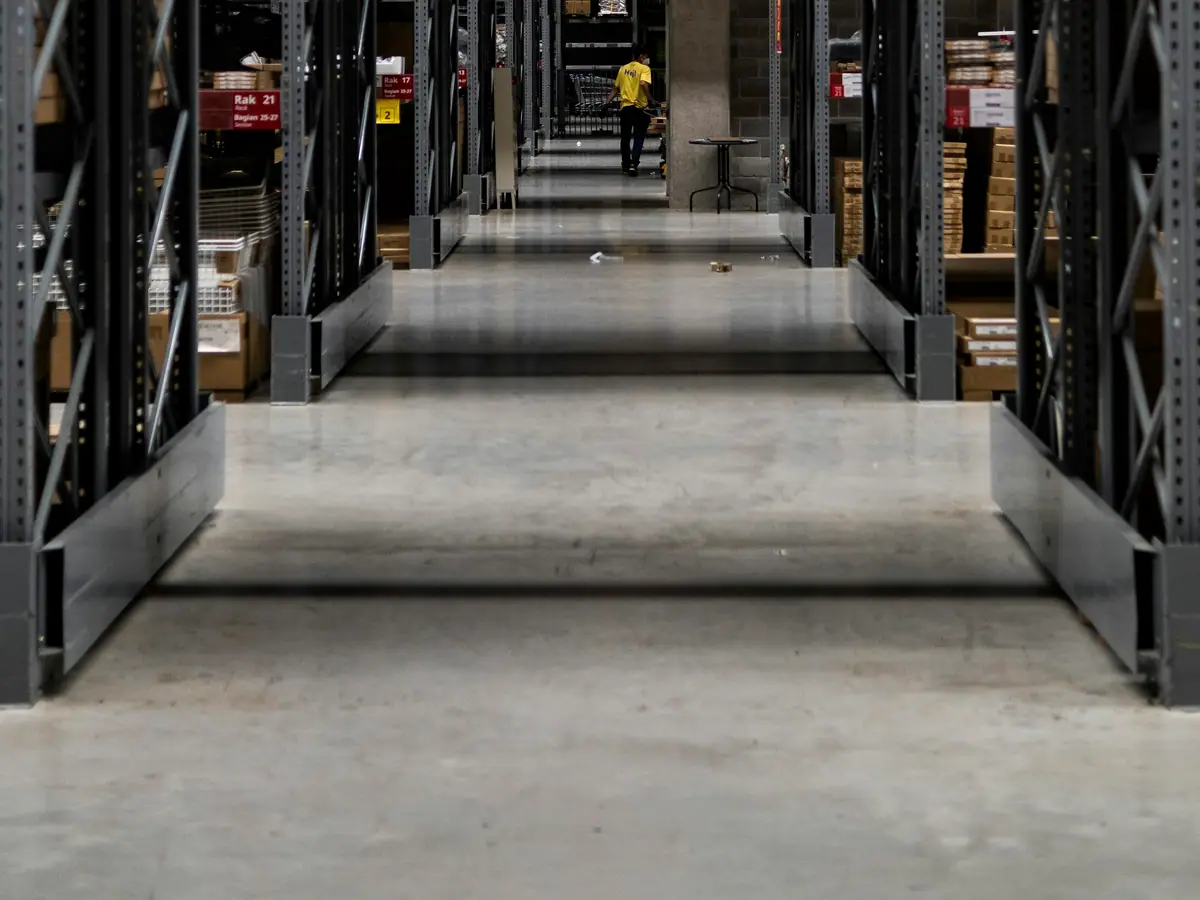 A long warehouse aisle between tall racks