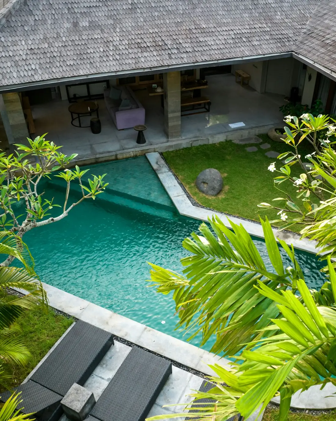 Aerial view of a tropical villa with a long pool