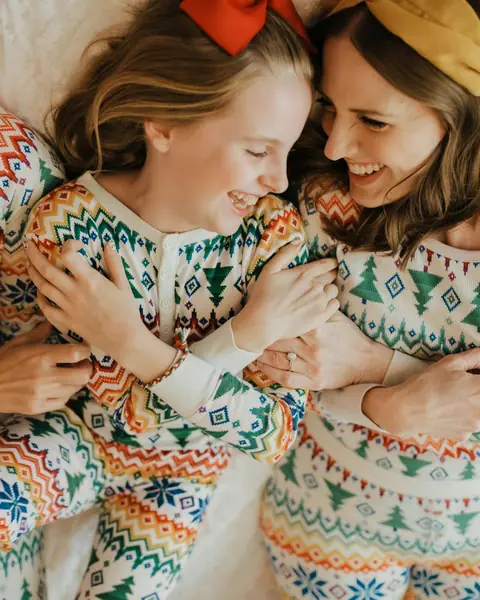 Friends laughing in matching printed pyjamas