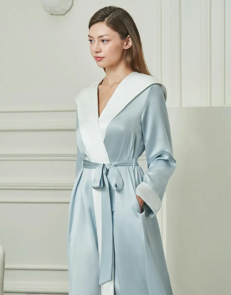 A woman in a pale blue satin robe with a white collar