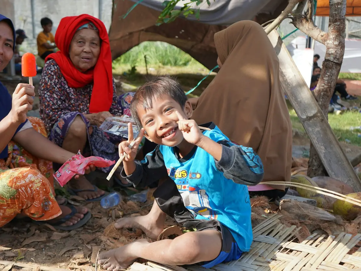 A family sitting together outdoors, laughing