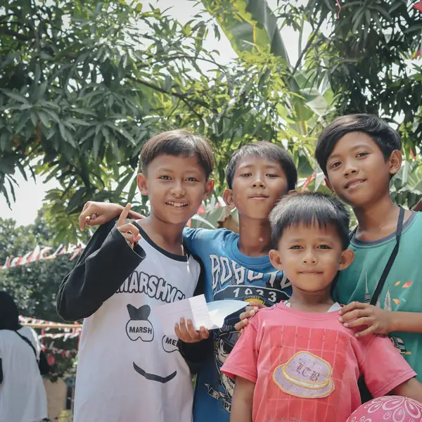 Four boys smiling together outdoors
