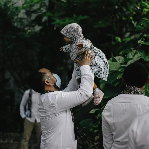 A father lifting his baby into the air