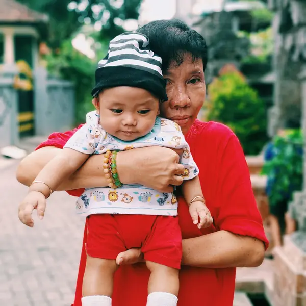 A grandmother holding a baby