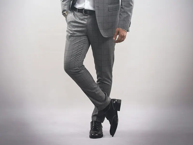 A man in a grey suit mid-stride